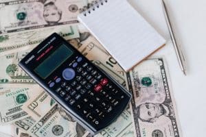 Calculator on a table with money: is owning a cleaning franchise worth it?